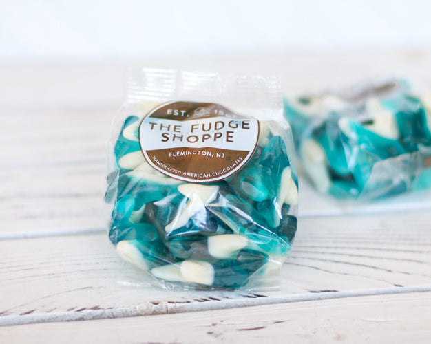 gummi sharks on a white wood background