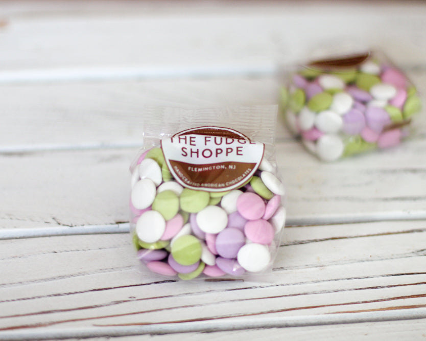 Packaged candy with 'The Fudge Shoppe' label on a wooden surface