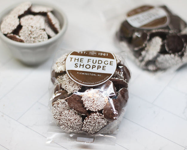 Chocolate Non Pareils on a white surface