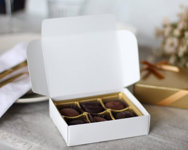 White box of chocolates on a table with a blurred background
