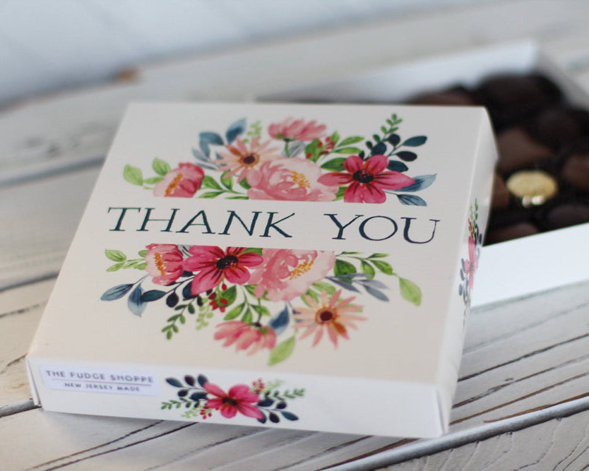 Box with floral design and 'Thank You' text on a wooden surface
