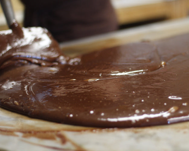 fudge being poured and spread onto a table