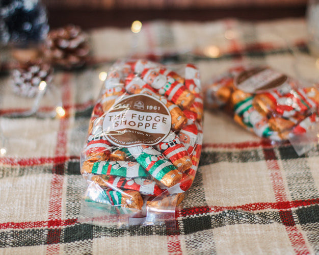 Foiled Chocolate Santas on a plaid tablecloth 