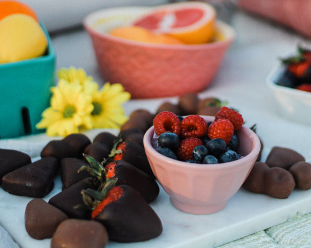 chocolate covered fresh fruit in a picnic setting