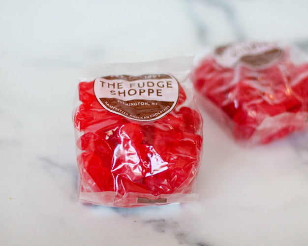 Red cinnamon bears from The Fudge Shoppe on a marble surface