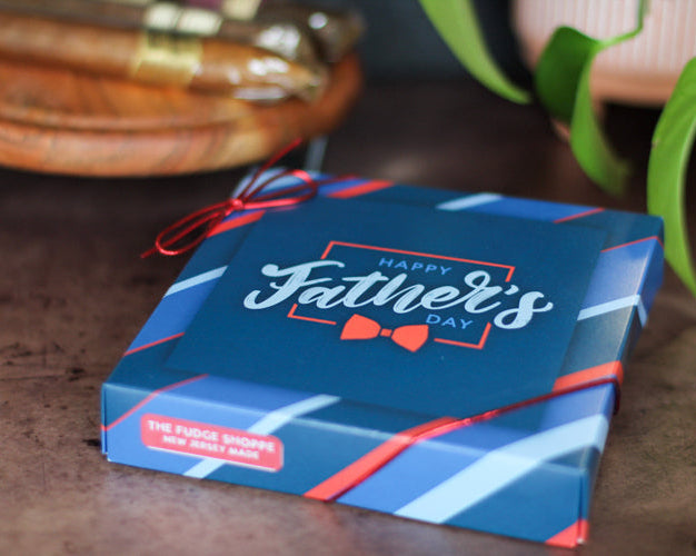 Blue gift box with 'Happy Father's Day' text on a wooden surface