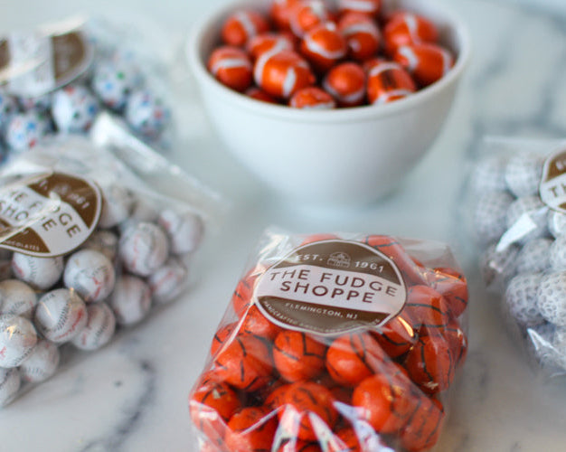 foiled sports balls on a marble background