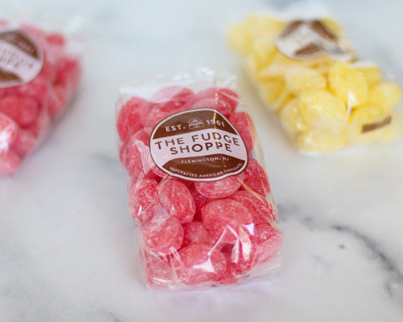 hard fruit drops candies on a marble surface
