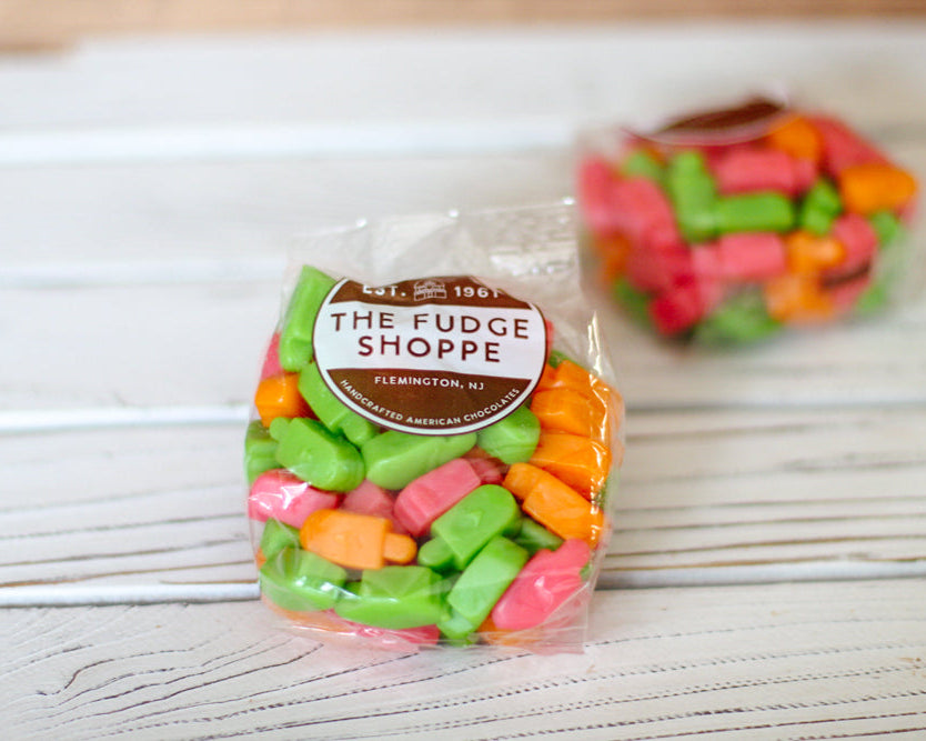 colorful gummi ice pops on a wood background
