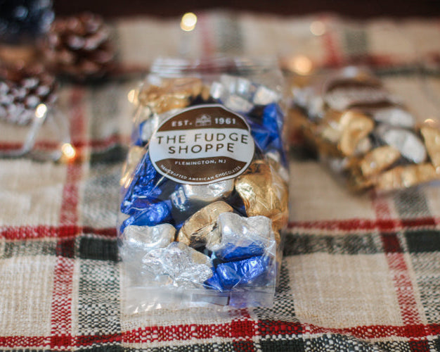 Packaged fudge from The Fudge Shoppe on a plaid tablecloth with blurred background