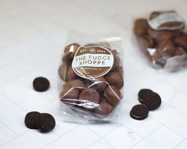Packaged mini oreos from The Fudge Shoppe on a white surface