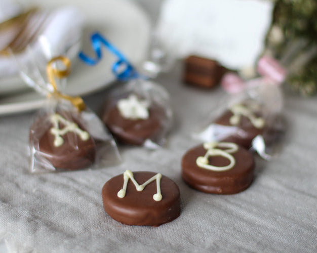 Chocolate cookies with decorative elements on a gray surface
