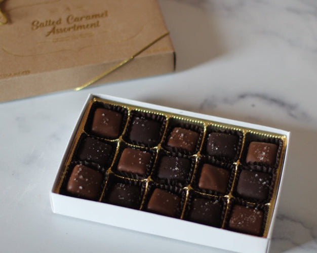 Box of salted caramels on a marble table