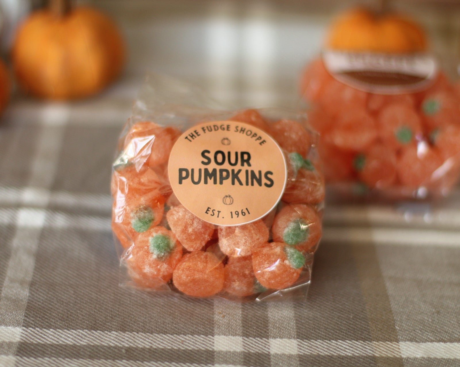 sour or kelly pumpkins on a checkered tablecloth