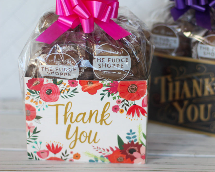 Two gift boxes with fudge, one floral and one with 'Thank You' text, on a light background.