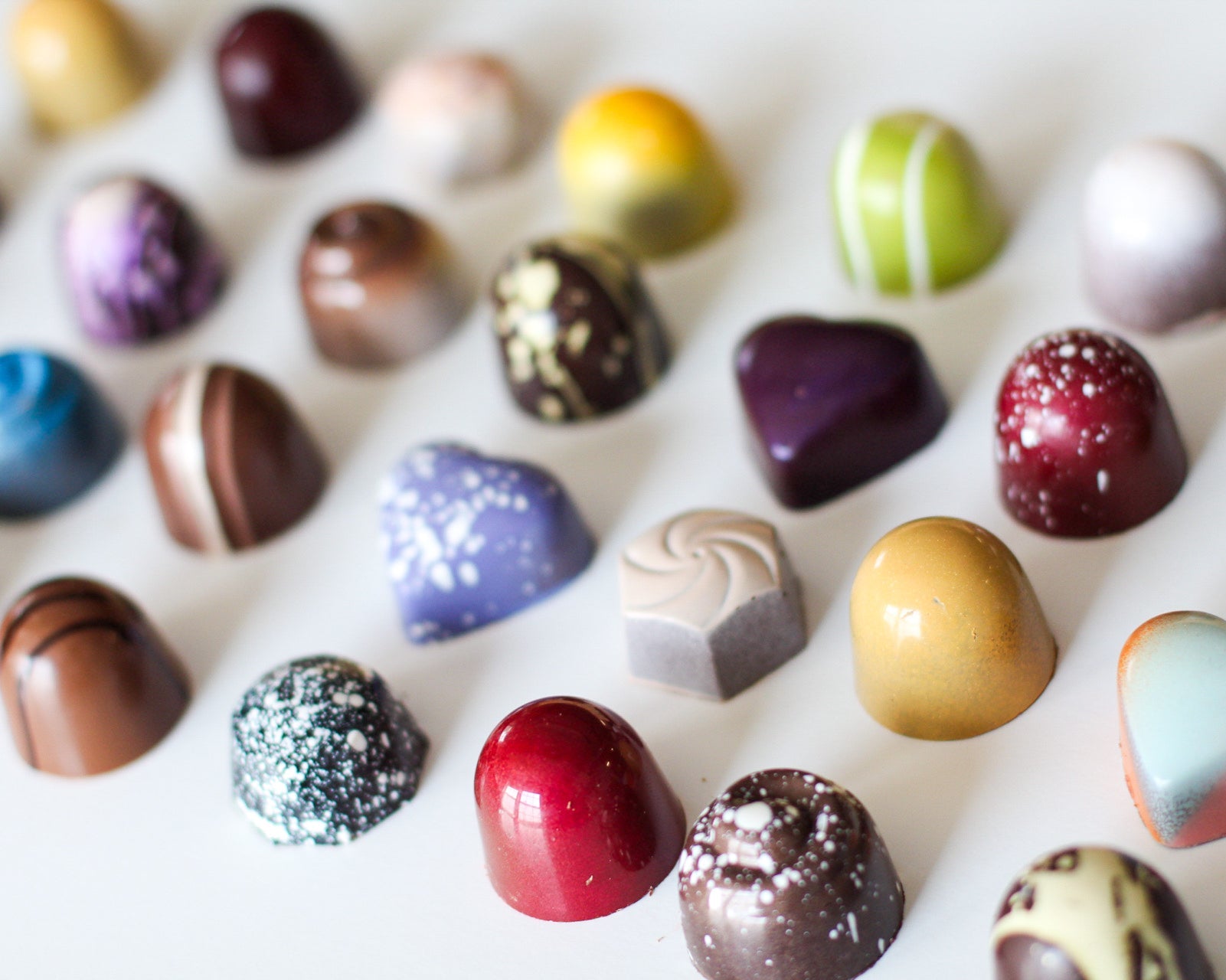 truffles of different flavors and designs on a white background