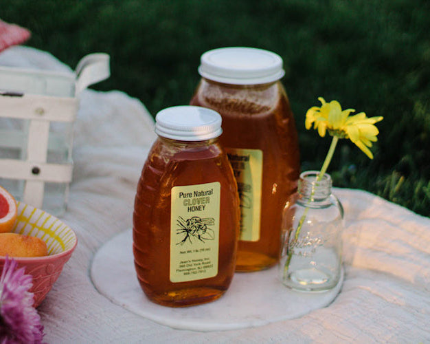 local honey in jars on a picnic 