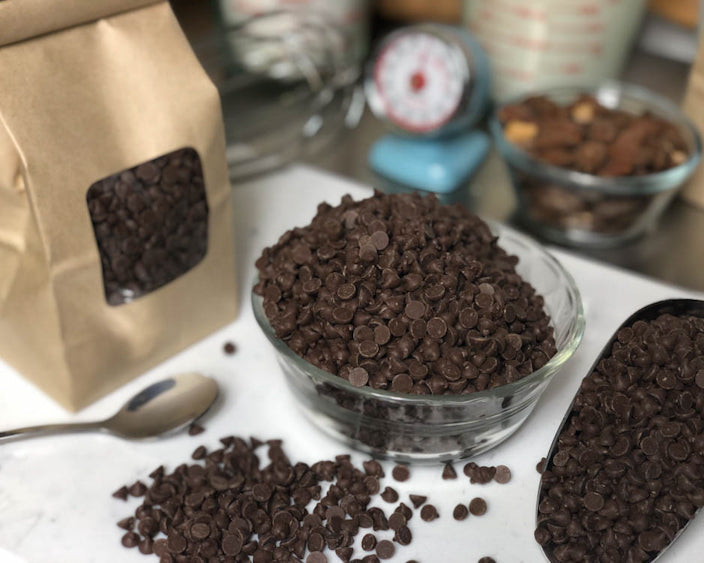 chocolate Chips in a cup with baking materials around