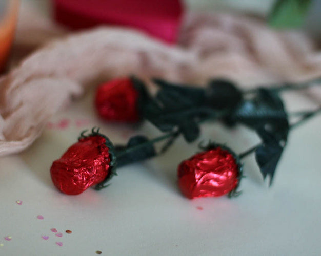 foiled chocolate roses on a white table