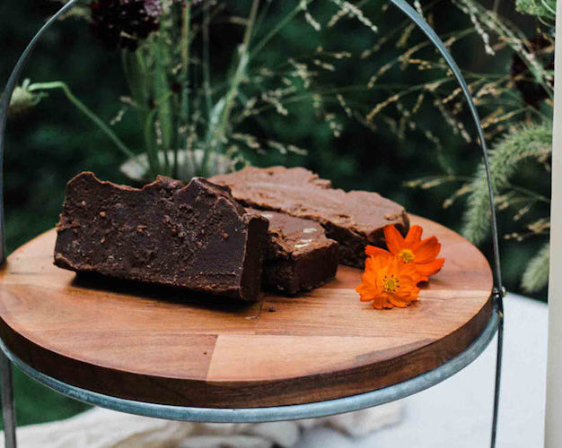 A variety of handcrafted fudge slices on a wooden board 