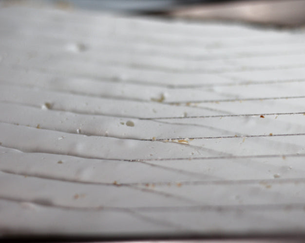 toasted coconut marshmallow being cut into squares